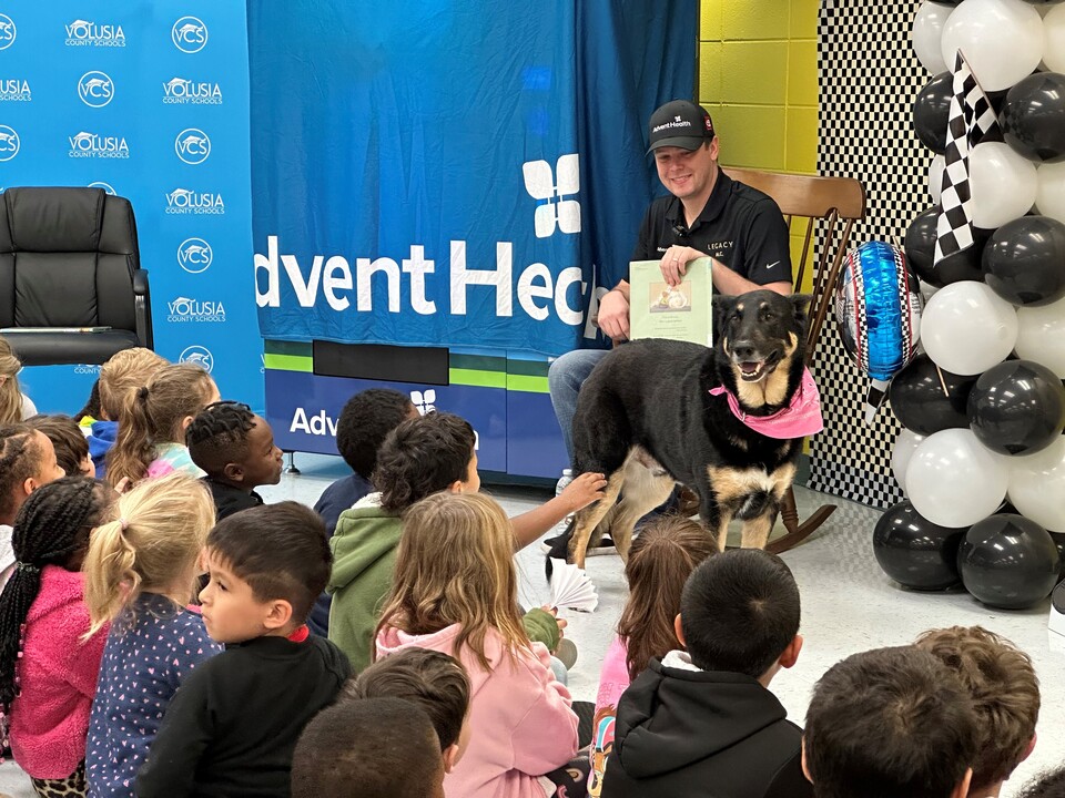 NASCAR Driver Reads to Children and Delivers a 